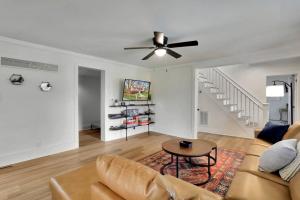 a living room with a couch and a ceiling fan at Hawksbill Home~Hot Tub~Dog Friendly~Modern~Water Front Porch in Luray