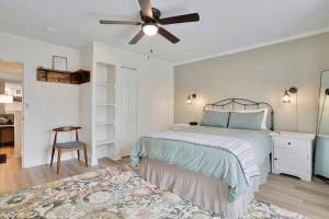 a bedroom with a bed and a ceiling fan at Hawksbill Home~Hot Tub~Dog Friendly~Modern~Water Front Porch in Luray