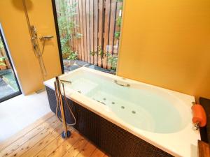 a bath tub in a bathroom with a window at Tsuruya / Vacation STAY 59052 in Miyaji +50 photos