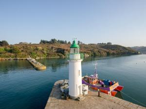 latarnia morska z łodzią na zbiorniku wodnym w obiekcie Studio charmant à Sauzon avec WiFi et vue port - FR-1-418-185 w mieście Sauzon +2 zdjęcia