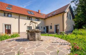 a house with a fountain in the yard at Cozy Apartment In Col With House A Panoramic View in Zoll