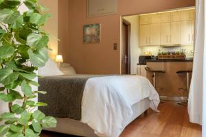 a hotel room with a bed and a kitchen at Armoniko in Athens +12 photos
