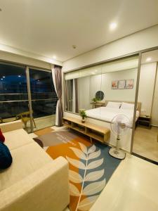 a large room with a bed and a fan at The Sóng Vũng Tàu - Bin's House in Vung Tau