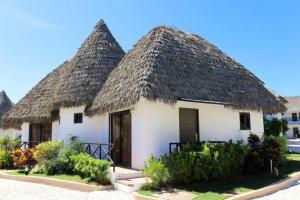 a group of huts with thatched roofs at Safari Hotel and Villas powered by Cocotel in Vigan