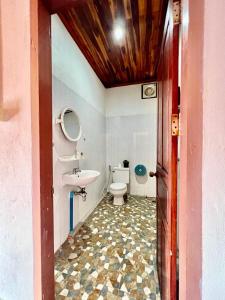 a bathroom with a toilet and a sink at La Casa Hostel in Luang Prabang