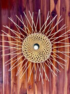 a wooden door with a wicker decoration on it at La Casa Hostel in Luang Prabang