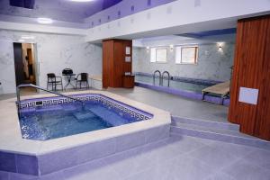 a large swimming pool in a room with at Hotel Inju in Borovoye