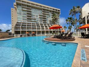 a large swimming pool in front of a building at Spectacular Ocean-View Condo in Beachfront Resort in South Padre Island