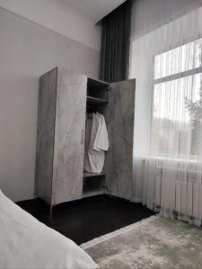 a bedroom with a large marble cabinet with a window at Hotel Inju in Borovoye
