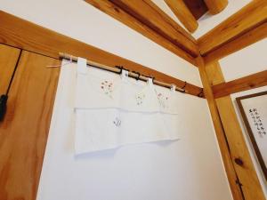 a room with white towels hanging on a wall at Jeonju Hanok village Deoksugung in Jeonju