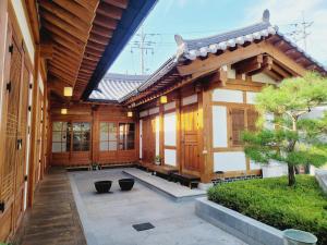 an asian building with a courtyard in front of it at Jeonju Hanok village Deoksugung in Jeonju