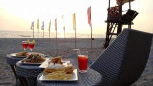 a table with food and drinks on the beach at Brisa Marina Beach Resort powered by Cocotel in Morong