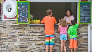 a group of children standing around a counter at Green Mountain Inn in Stowe