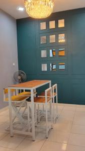a dining room with a table and chairs and a chandelier at MAS'homestay perlis in Kangar +17 photos