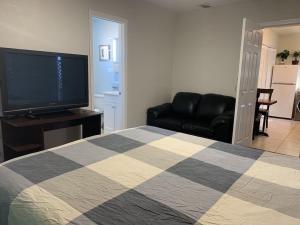 a bedroom with a bed and a flat screen tv at SFO New Comfortable Studio in San Bruno