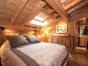 una camera con un grande letto in una cabina di Chalet Chamonix-Mont-Blanc, 6 pièces, 8 personnes - FR-1-343-224 a Chamonix-Mont-Blanc