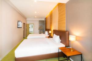 1 dormitorio con 2 camas, mesa y lámparas en International Hotel in Ulaanbaatar, en Ulán Bator