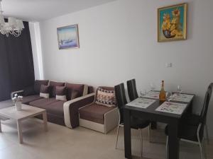 uma sala de estar com um sofá e uma mesa em Green Life Beach Resort Paradise Apartment em Sozopol