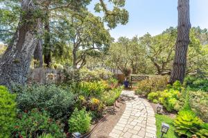 a garden with flowers and a pathway at 3891 Robert R Jones House home in Carmel