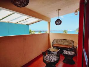 a balcony with a bench and a table at Le Blue Coast in Progreso