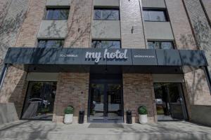 a hotel with a sign on the front of a building at My Hotel Bishkek in Bishkek