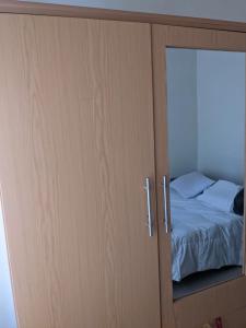 a cupboard with a bed inside of it at Ignite guest and apartment in Rubavu