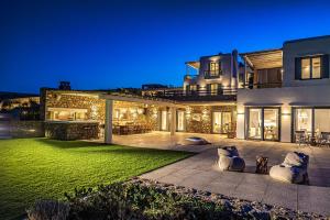 a large house with a lawn in front of it at Villa Elia by Mykonian Kazarte in Kalafatis