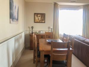 a dining room with a table and chairs and a window at Coastal Hideaway in Sandown