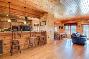 a kitchen and living room with a bar in a log cabin at 518MTNVIEWLDGEACNCB - Mountain View Lodge in Gatlinburg