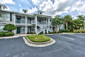 a large white building with a parking lot at Solterra, Luxury Condo, Resort Pool in Greenlinks in Naples