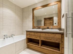 a bathroom with a tub and a sink and a mirror at Appartement de Luxe avec Cheminée, Jacuzzi et Hammam, Skis aux Pieds - Méribel - FR-1-613-84 in Les Allues +6 photos