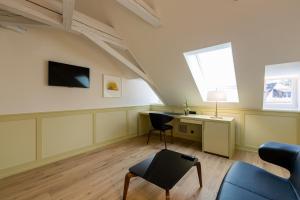 a living room with a desk and a window at Hotel Krone Speicher in Speicher