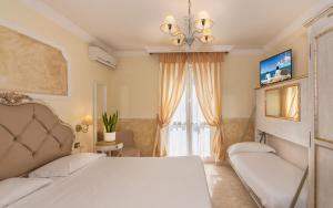 Postel nebo postele na pokoji v ubytování Hotel Tahiti