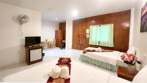 pokój hotelowy z łóżkiem i telewizorem w obiekcie Mild Garden View Resort w Aonang Beach