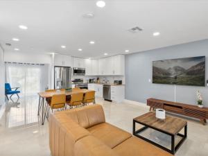 a living room with a couch and a table at 43 Terrace Newly Renovated Modern Home in Fort Lauderdale