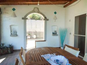 a dining room with a wooden table and a window at Villa Valfrida in San Teodoro +27 photos