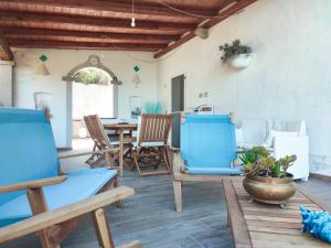 a patio with blue chairs and a table at Villa Valfrida in San Teodoro