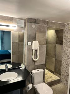 a bathroom with a toilet and a sink at Hotel du Dragon in Paris