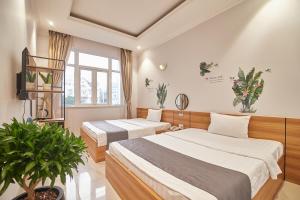 Giường trong phòng chung tại Bin Bin Hotel 2 - Near Him Lam D7