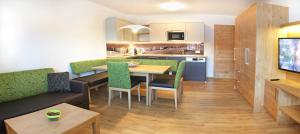 a kitchen and dining room with a table and chairs at Tarlack Appartements Hütten 1a in Leogang
