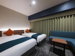 une chambre d'hôtel avec deux lits et un canapé dans l'établissement Hotel Villa Fontaine Tokyo-Ueno Okachimachi, à Tokyo