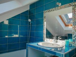 a blue bathroom with a sink and a mirror at Maison Sauzon, 5 pièces, 8 personnes - FR-1-418-201 in Sauzon