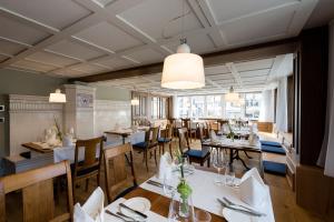 a dining room with tables and chairs in a restaurant at Hotel Krone Speicher in Speicher