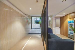 a hallway of a house with a blue couch at Bin Bin Hotel 2 - Near Him Lam D7 in Ho Chi Minh City