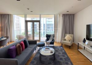 a living room with a couch and a tv at Crystal Clear 1BR Apt in Blue Waters by Rich Stay in Dubai