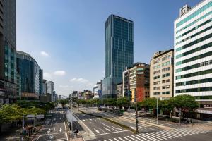 a city with tall buildings and a street with cars at Solaria Nishitetsu Hotel Taipei Ximen in Taipei