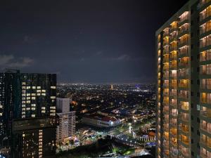 a view of a city at night from a building at Alexa at Tanglin Apartemen in Surabaya