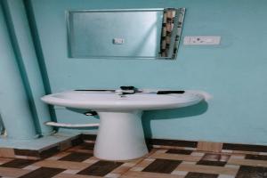 a bathroom with a white sink and a mirror at SPOT ON Pushpanjali Guest House in Patna
