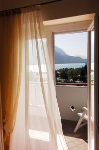 a room with a window with a view of the ocean at Hotel Lido - green & slow life in Molveno