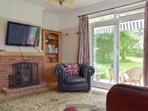 a living room with a fireplace and a television at Bella Vista in Ryde